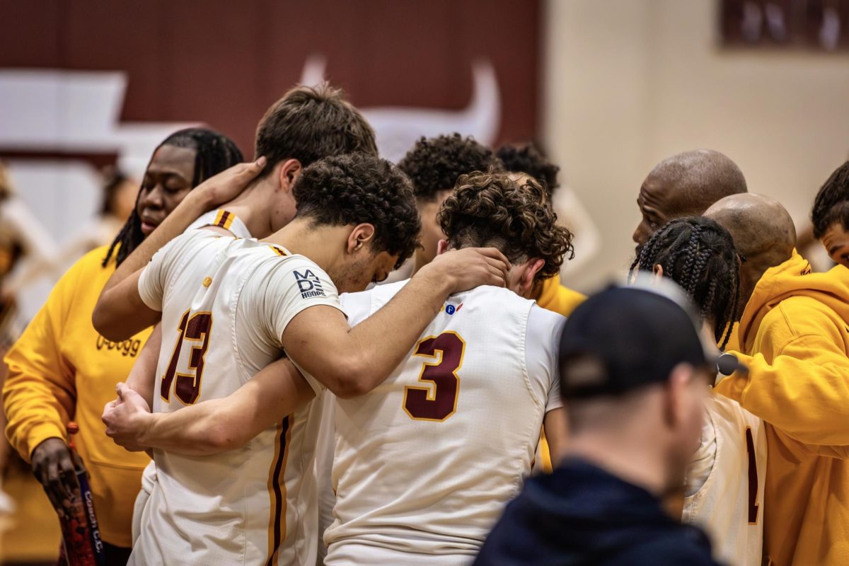 Roosevelt Boys Basketball team huddling up during intense battle